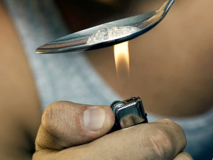 Close-up of a young man heating a spoon with a lighter Original Filename: medfrd2146.jpg
